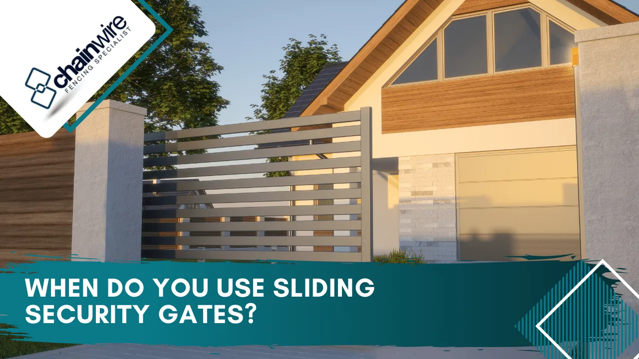 A sliding security gate mounted along a fence line