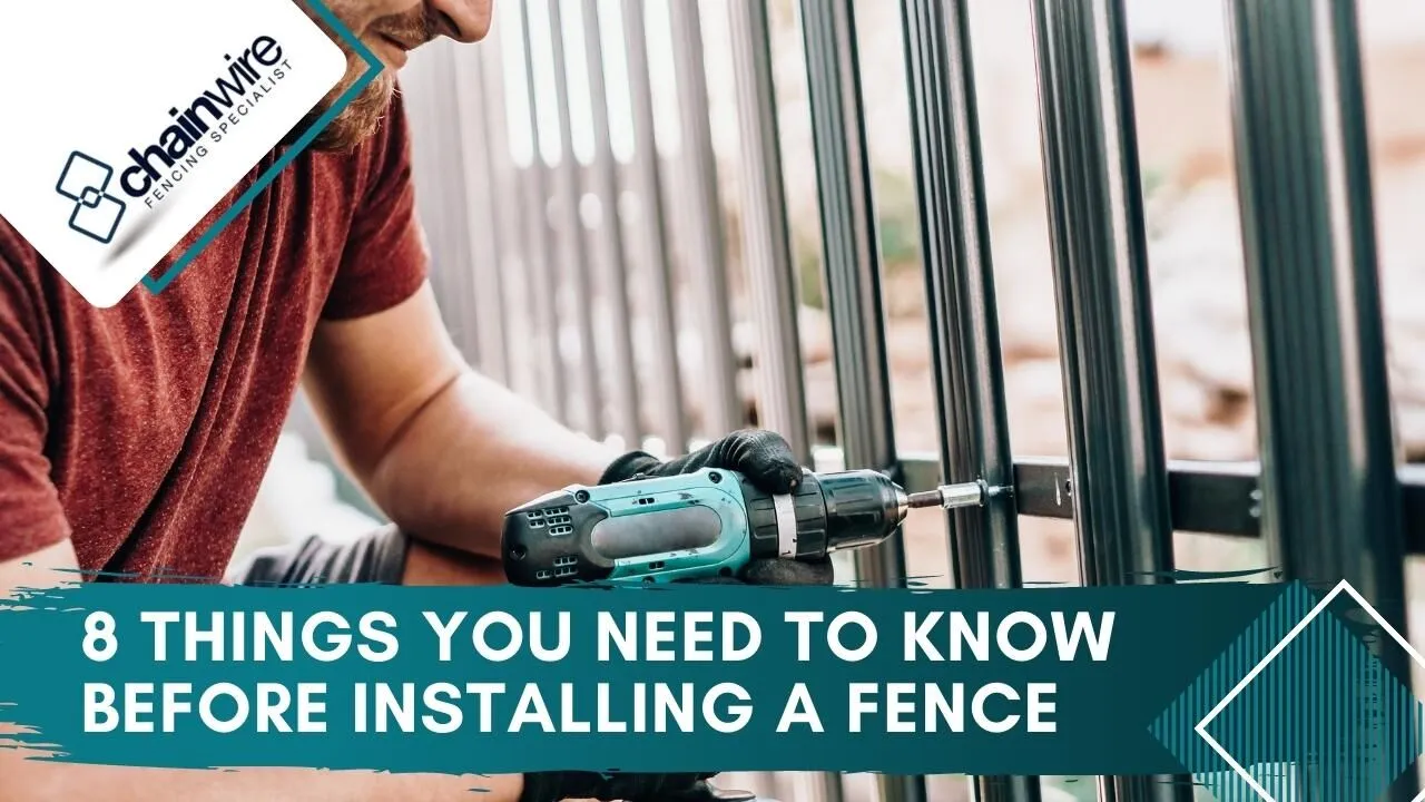 New chainwire fence being installed along a residential boundary line