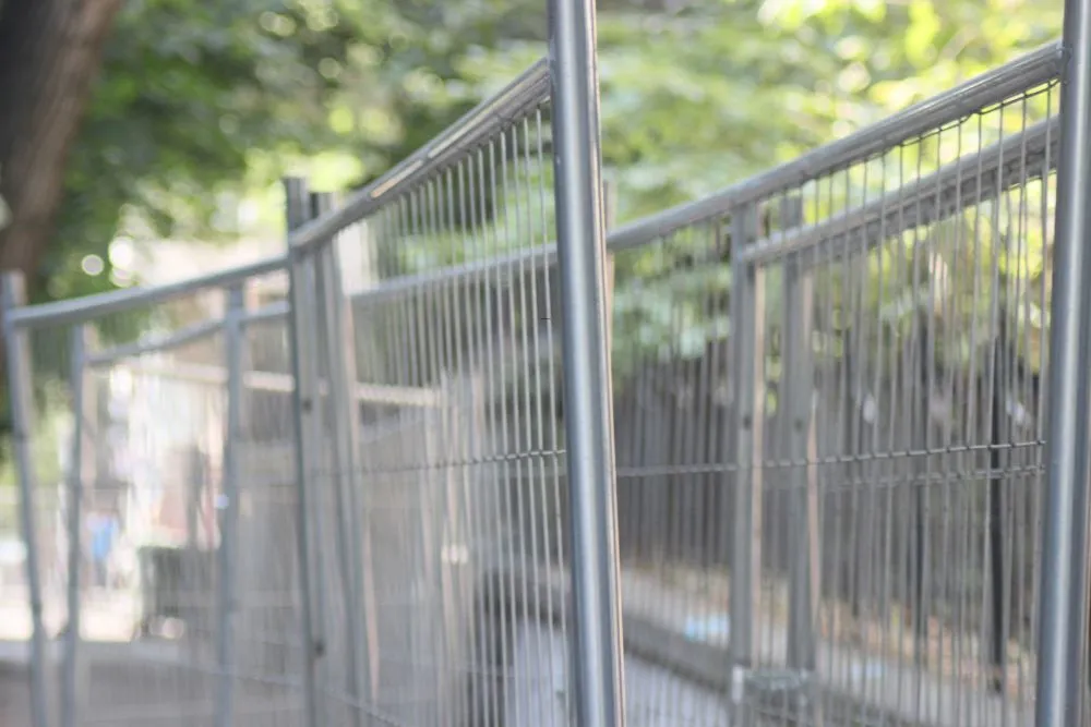 Temporary fencing panels enclosing an active construction site