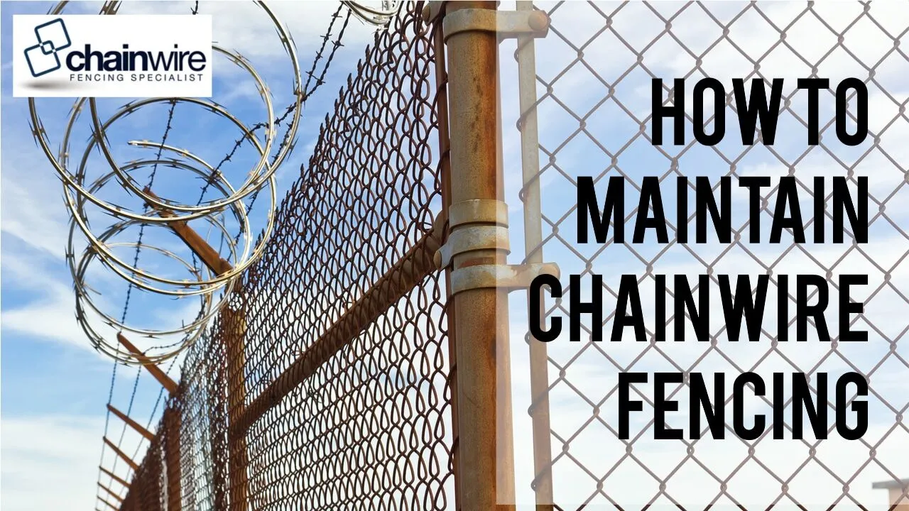 A galvanised chainwire fence being cleaned and inspected