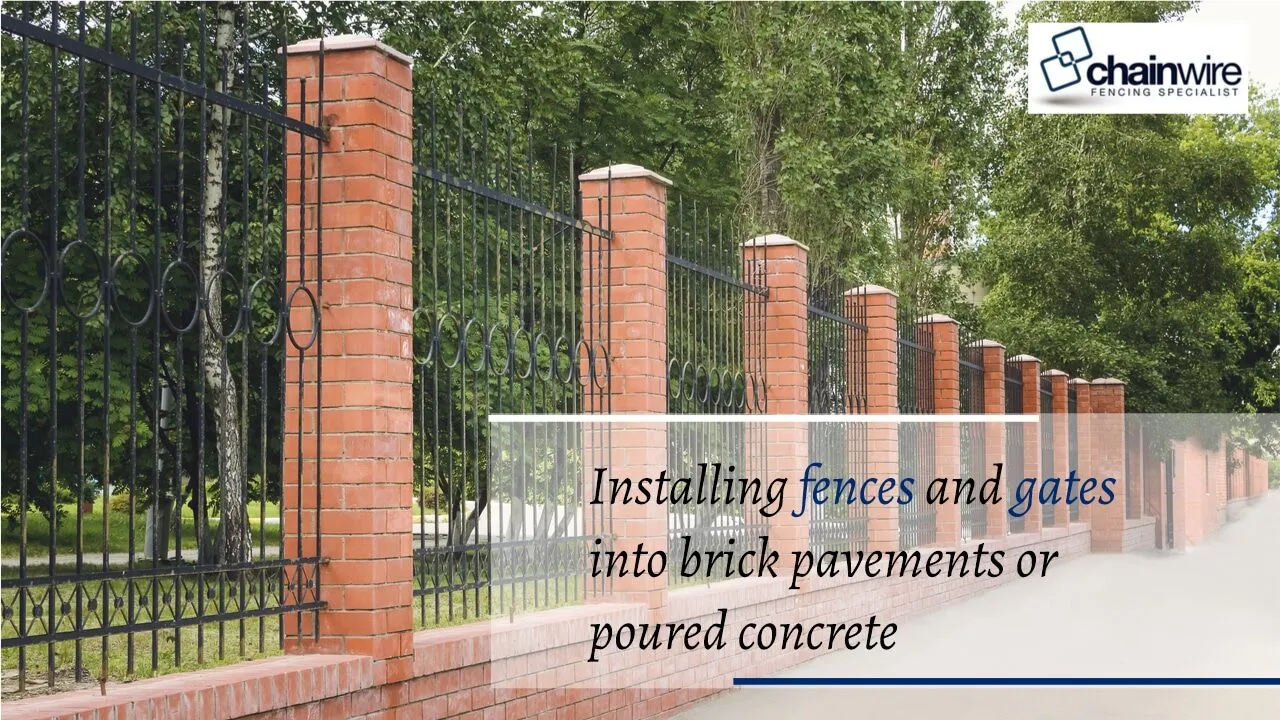 A fence post being fixed into a brick paved surface