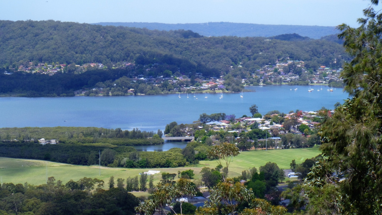 Overlooking green fields and waterfront suburbs on the Central Coast with moored boats