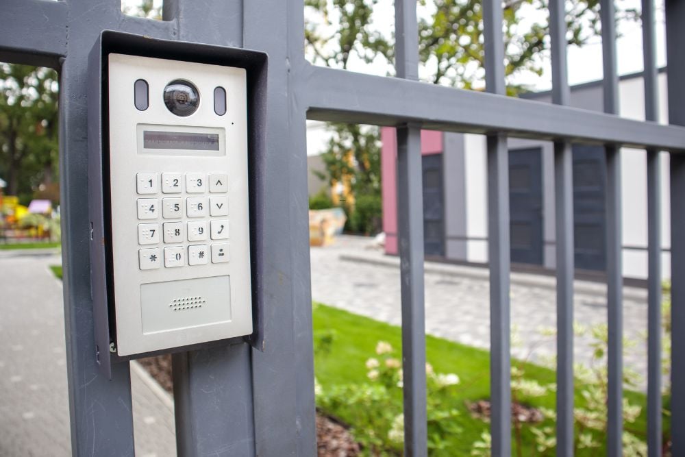 Access control keypad mounted on steel gate for Chainwire Fencing Specialist site security