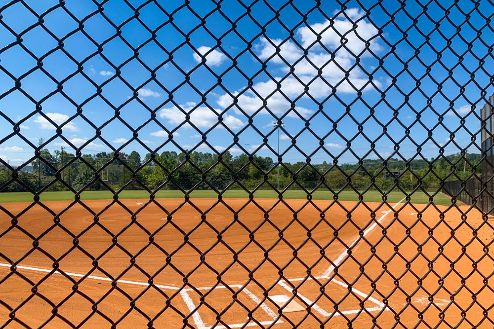 Chainwire Fencing Specialist enclosure around outdoor sports field with marked baseball diamond