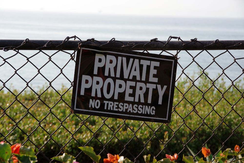 Private property no trespassing sign attached to chainwire fence by Chainwire Fencing Specialist
