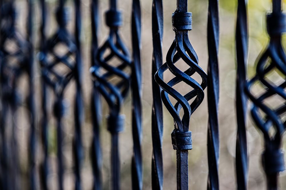 Close-up of decorative PVC-coated fence with lattice detail installed by Chainwire Fencing Specialist