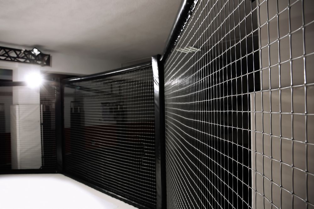 Indoor steel mesh storage cage installed by Chainwire Fencing Specialist for secure access control